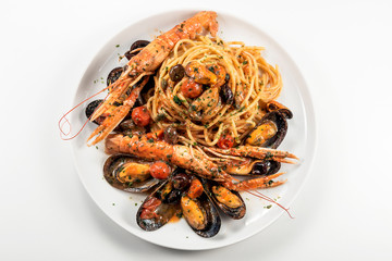 Plate of spaghetti with prawn mussels olives and tomatoes