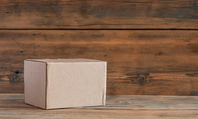 Cardboard box on a wooden background