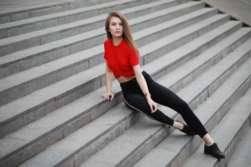 A girl posing on the steps of a building