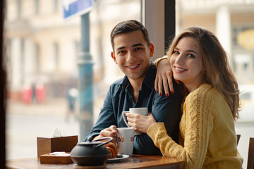 Young couple in love sitting in a cafe, drinking coffee © arthurhidden