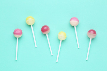 Sweet lollipops on mint background