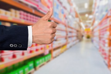 Businessman showing thumbs up  over blue background