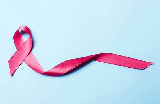 Pink, red ribbon on a blue background.