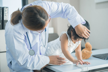 Asian doctor using a stethoscope to check his breathing and heart of a lovely girl, check the health of children,Thailand people