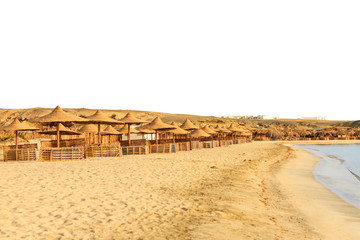beach on the shores of the desert with sun beds and umbrellas