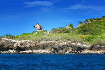 little house stand is rock in the sea.