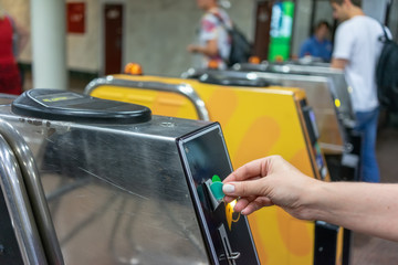 Hand insert subway chip into entrance machine