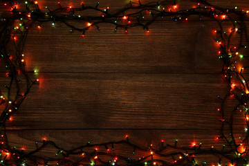 Christmas garland lights on brown wooden table