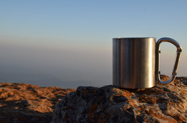 A cup of tea on stone with a view of the Mountain in the background.