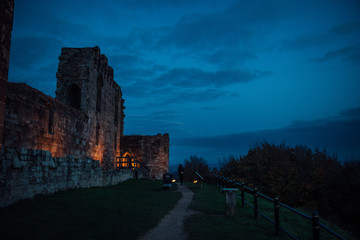 Beautiful sunset on ancient Stafford Castle with colorful sky and light on castle.