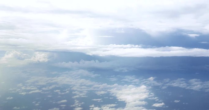 Flight over clouds, a view from a plane window - beautiful blue sky