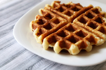Belgian waffles on white plate. Homemade dessert
