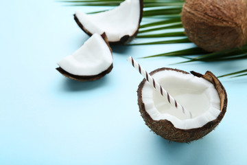 Coconut water with straw on blue background