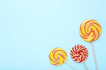 Colorful lollipops on blue background