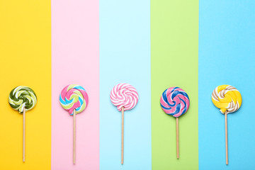 Sweet lollipops on colorful background