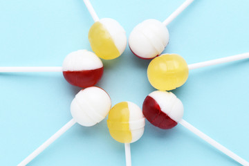 Sweet lollipops on blue background