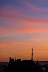 Paris skyline at sunset with silhouette of Eiffel Tower and colourful sky