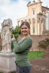 Fototapeta na wymiar woman in front of antique romanian sculpture