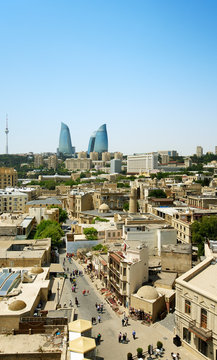 View of old city with Flame Towers in background against clear sky