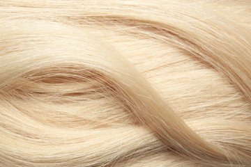 Texture of healthy blond hair as background, closeup