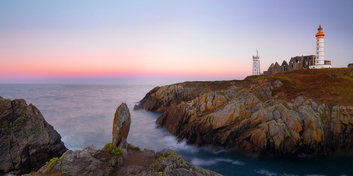 France, Brittany, Finistere, Pointe St. Mathieu, Saint Mathieu lighthouse and menhir at dawn