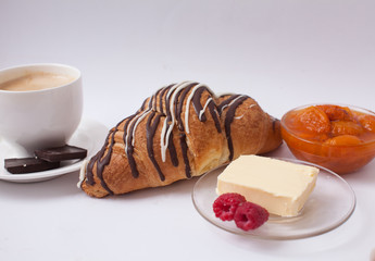 Close up to sweet croissant with copy space. Jam and butter in breakfast. Fresh buns