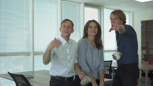 Office workers shows friendly gestures on camera