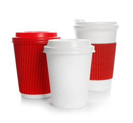 Takeaway paper coffee cups with lids on white background. Space for design