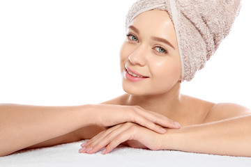 Portrait of young pretty woman with towel on white background