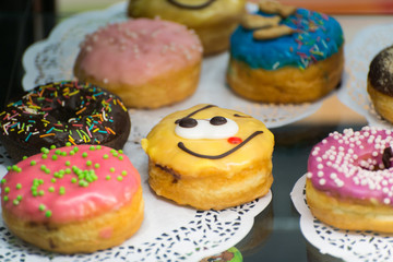 glazed doughnut with a smiley face on the counter confectionery