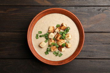 Obraz na płótnie Canvas Bowl of fresh homemade mushroom soup on white background, top view