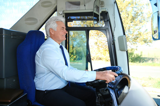 Professional Bus Driver At Steering Wheel. Passenger Transportation