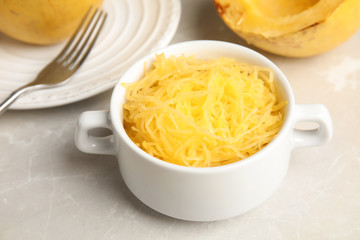 Cooked spaghetti squash in bowl served on table
