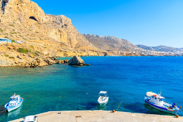 Fototapeta na wymiar Fishing boats on turquoise sea water in Finiki port, Karpathos island, Greece