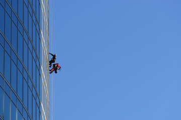 Window washers work on a skyscraper.