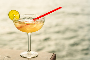 Close up of mojito with lime and red straw
