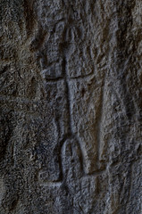 Obraz premium Neolithic rock paintings of Gobustan National Park, depicting dancing shaman holding spear in his hand, Azerbaijan,Caucasus,unesco heritage site