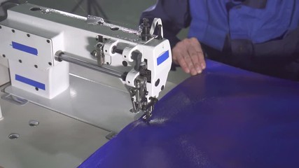 portrait of a man behind a sewing machine