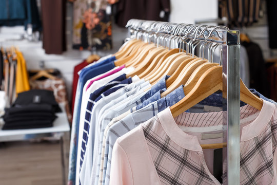 Fashion clothes on hangers and shelfs