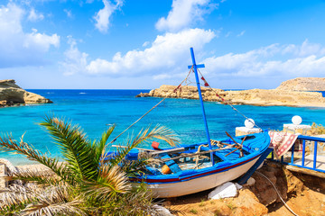 Fishing boat on beautiful beach in Lefkos village on coast of Karpathos island, Greece.