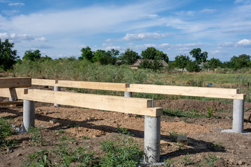 Fototapeta premium Foundation construction. Unfinished frame house. Building process of the A-type frame house.