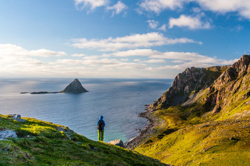 Girl hiking on Matinden trail with Bleiksoya islet in background, Vesteralen, Norway