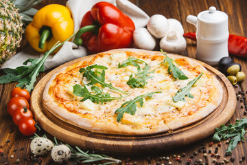 Hawaiian pizza on wooden plate
