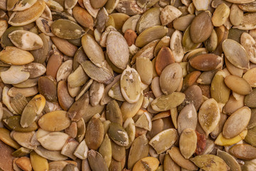 Heap of fresh pumpkin seeds background. Close up