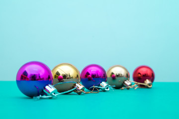 Christmas ornament balls and santa hat on grey background.