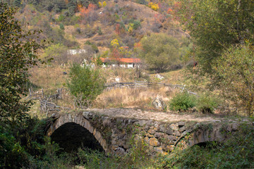 Fototapeta na wymiar Old Roman Bridge in Rhodope Mountains near the village of Fotinovo, Bulgaria.