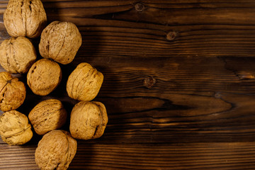 Walnuts on wooden table. Top view, copy space
