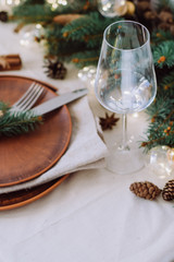 Table with Christmas decorations and garland, ware, green spruce branches