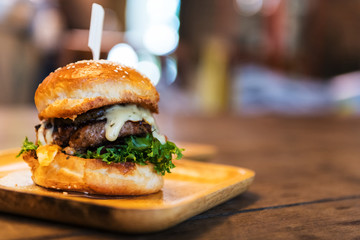 Hamburger and French fries on the wooden tray
