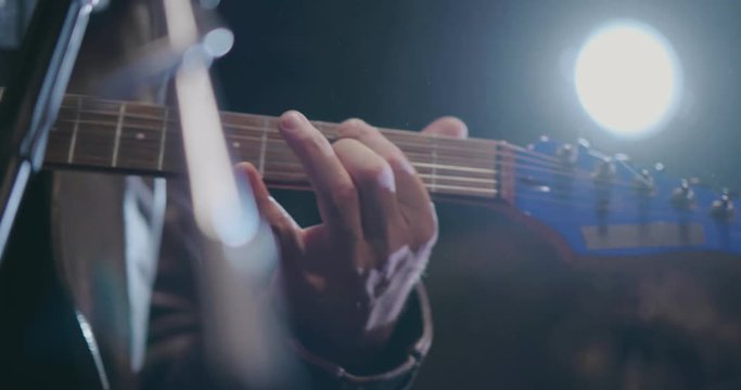 Close up of musician hand playing chords on electric guitar